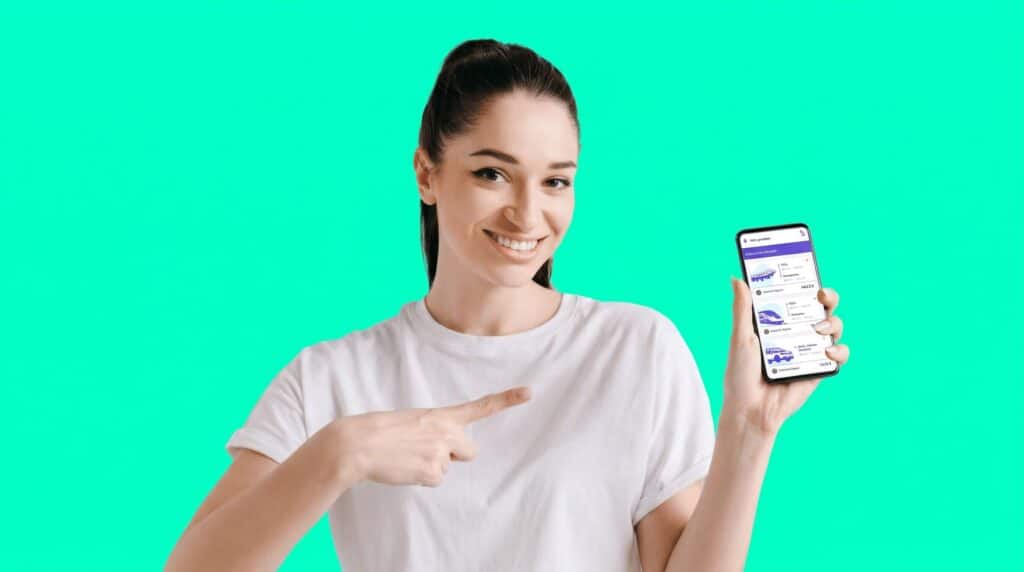 Une jeune femme souriante sur fond vert montrant du doigt l'écran de son smartphone affichant l'interface de la Supertripper application mobile.